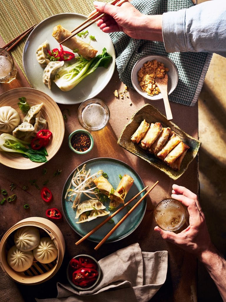 A table topped with plates of food and drinks